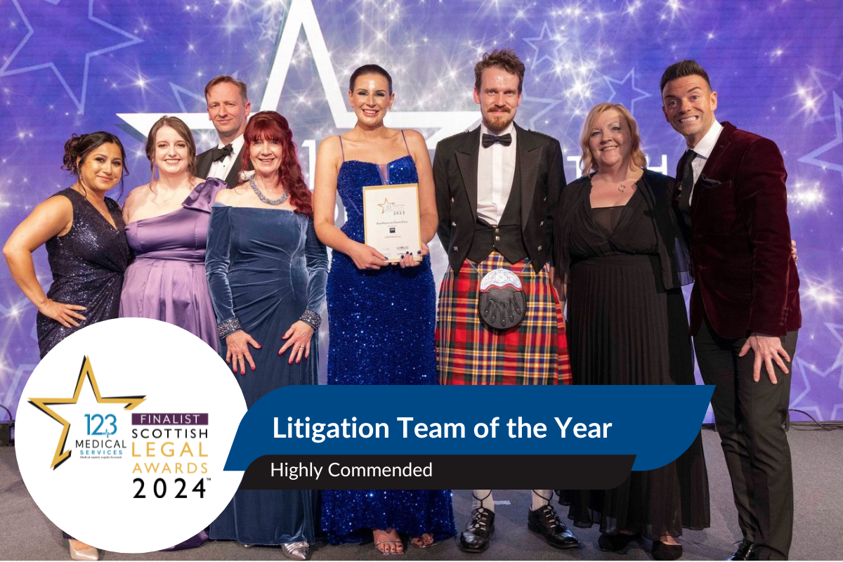 L&M Medilaw litigation team on stage holdin an award facing to camera